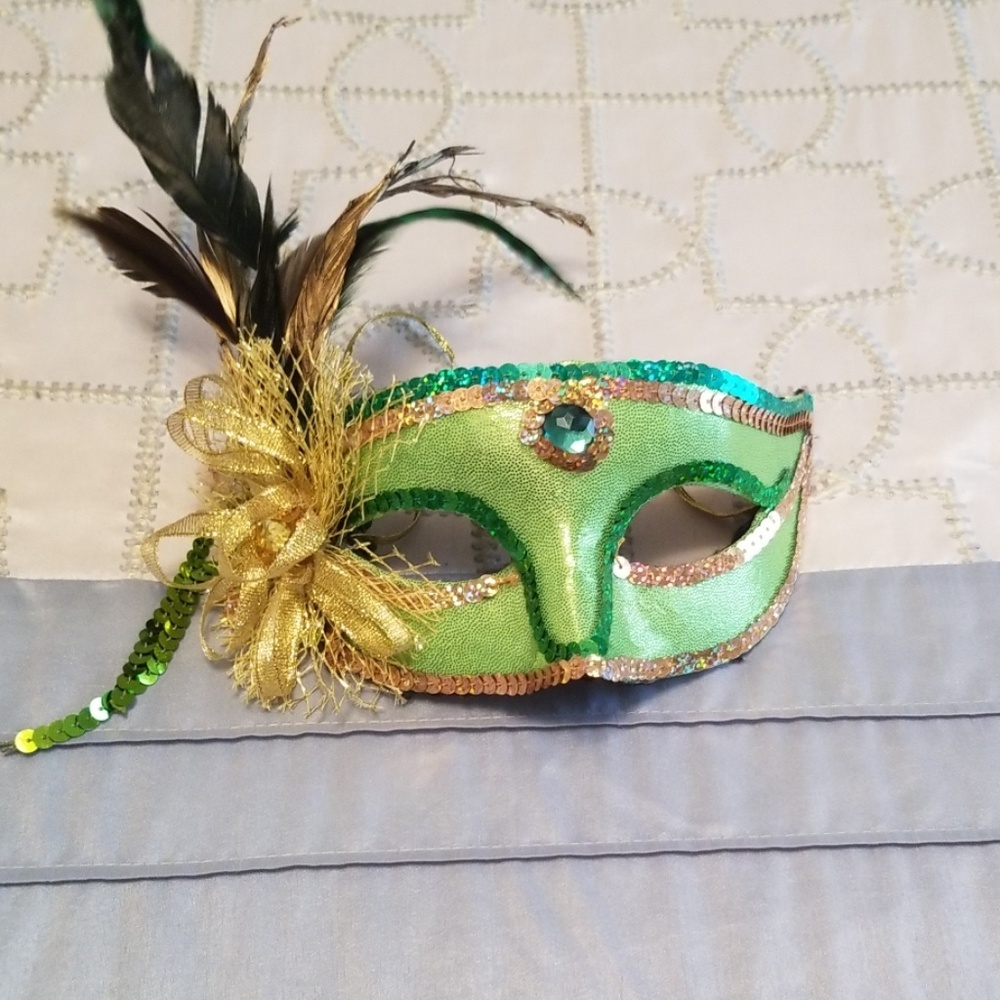 Green and gold feather embellished mask.